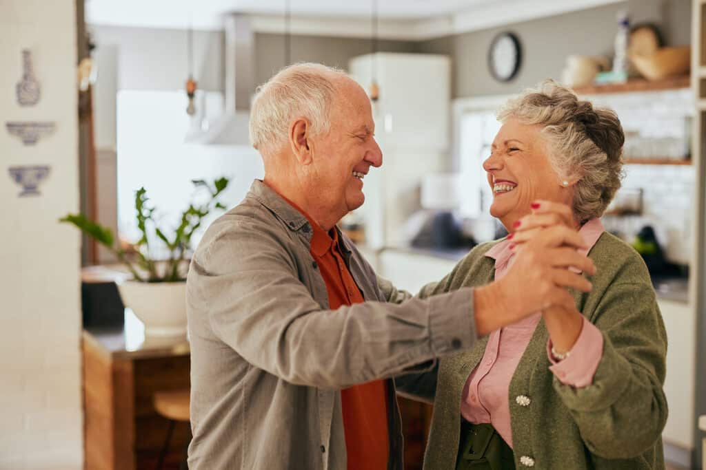 Happy couple dancing at home