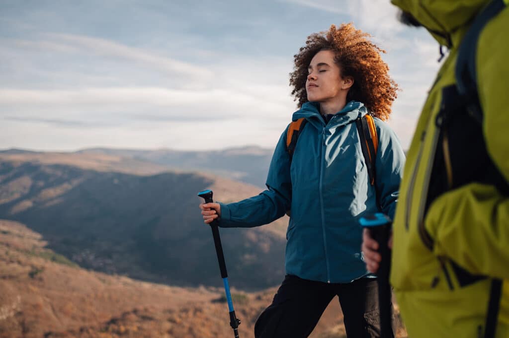 Hikers breathing in fresh air while taking in the breathtaking view from the mountain peak