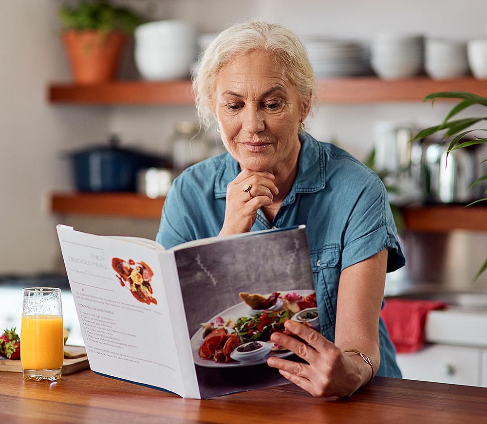 Woman reading a cook book