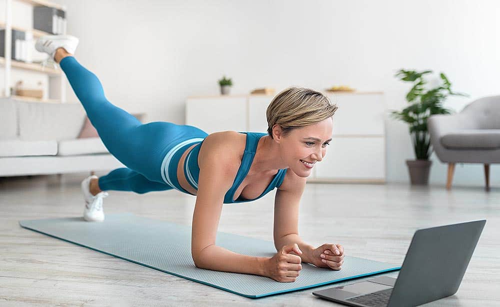 Woman doing remote workout at home