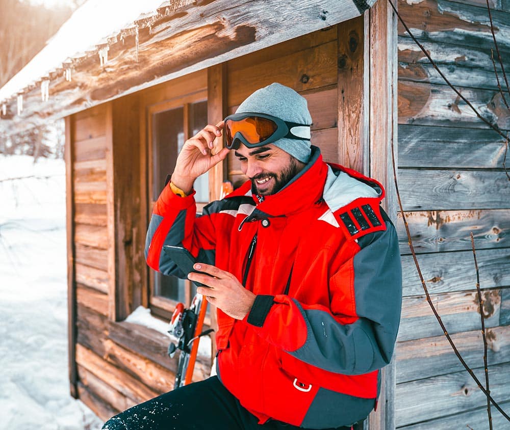 Skier looking at his phone