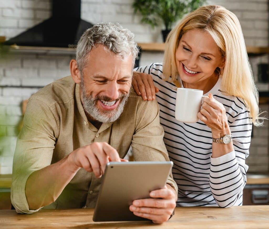 Couple looking at tablet together in kitchen
