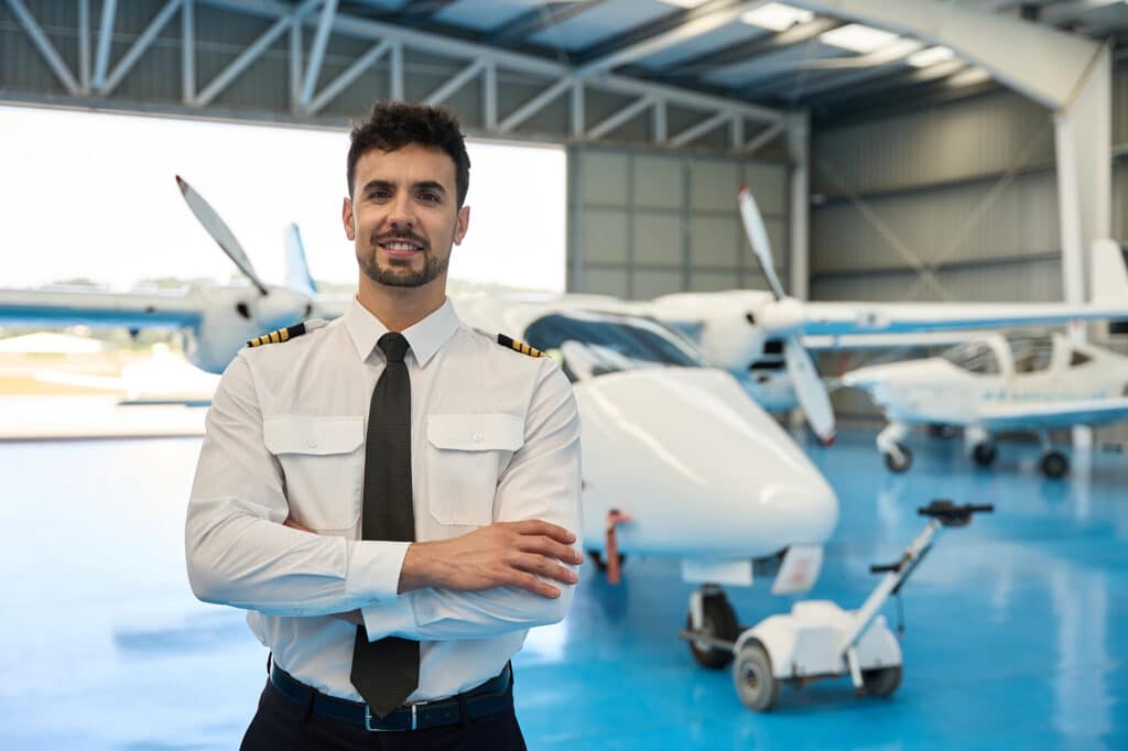 Pilot and airplane in the background